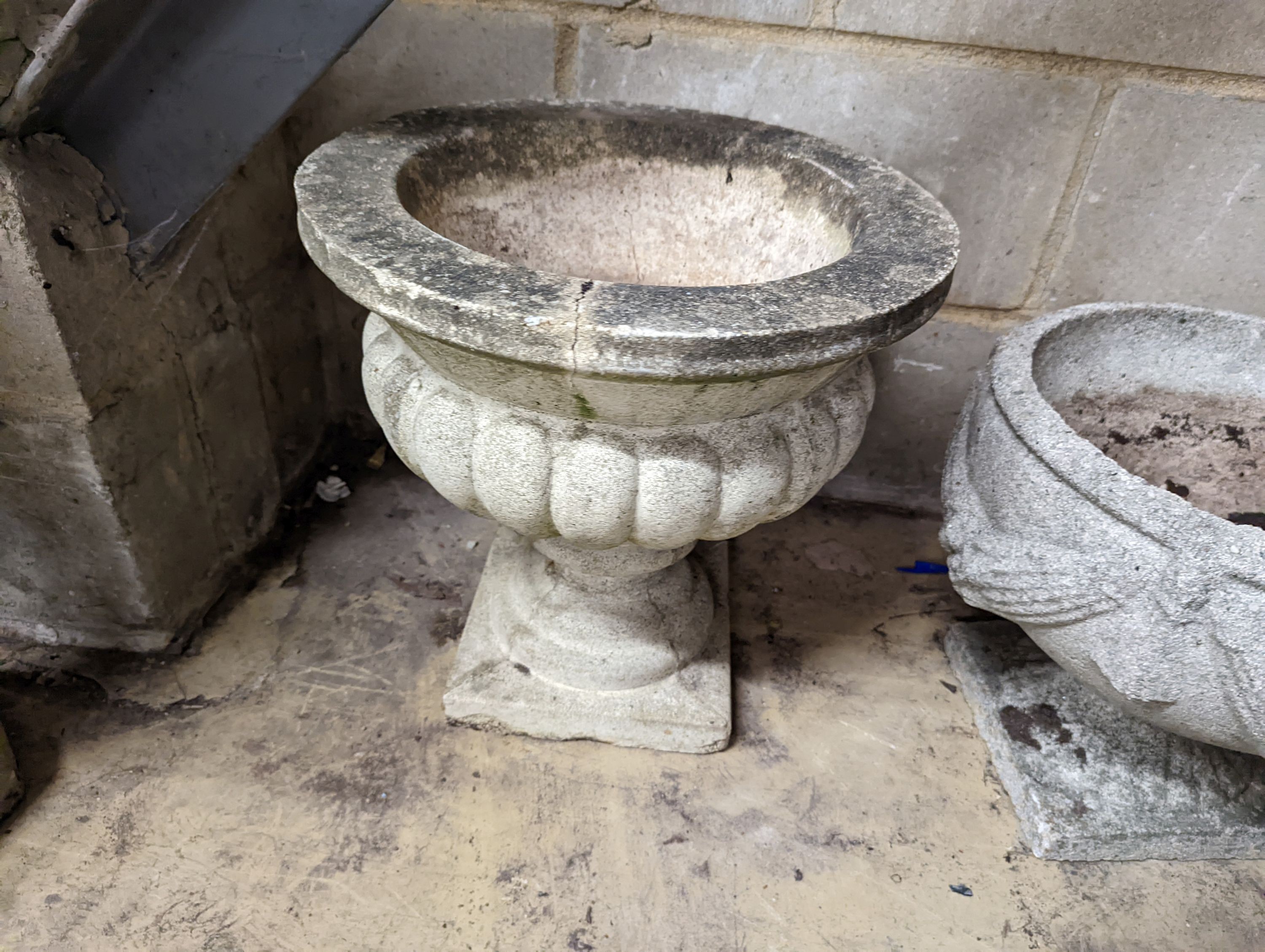 Six reconstituted stone garden planters, four lacking bases, largest diameter 41cm
